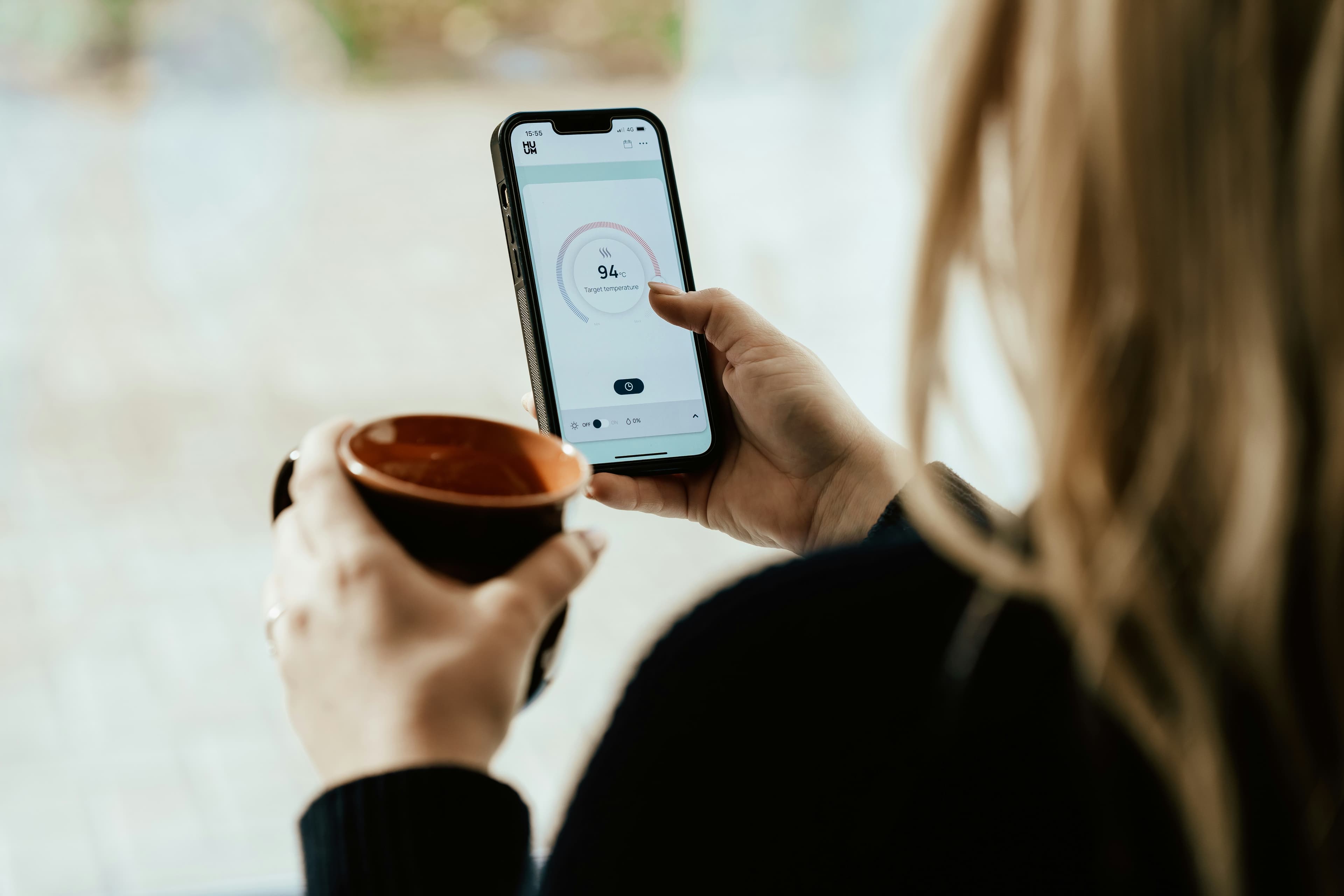 A patient checking a health app on their phone at home